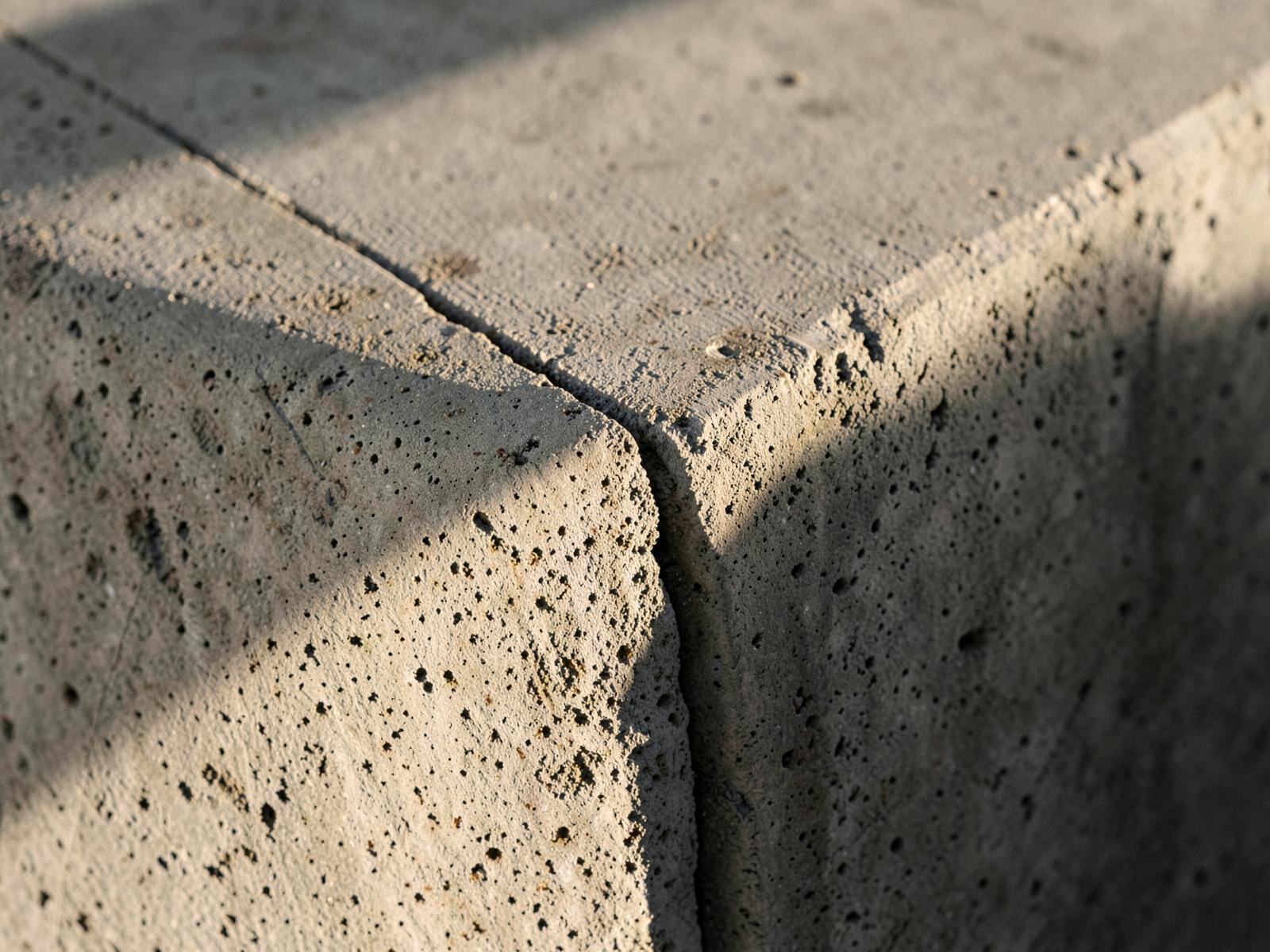 Close detail of a precast concrete panel joint with a sharp shadow line.