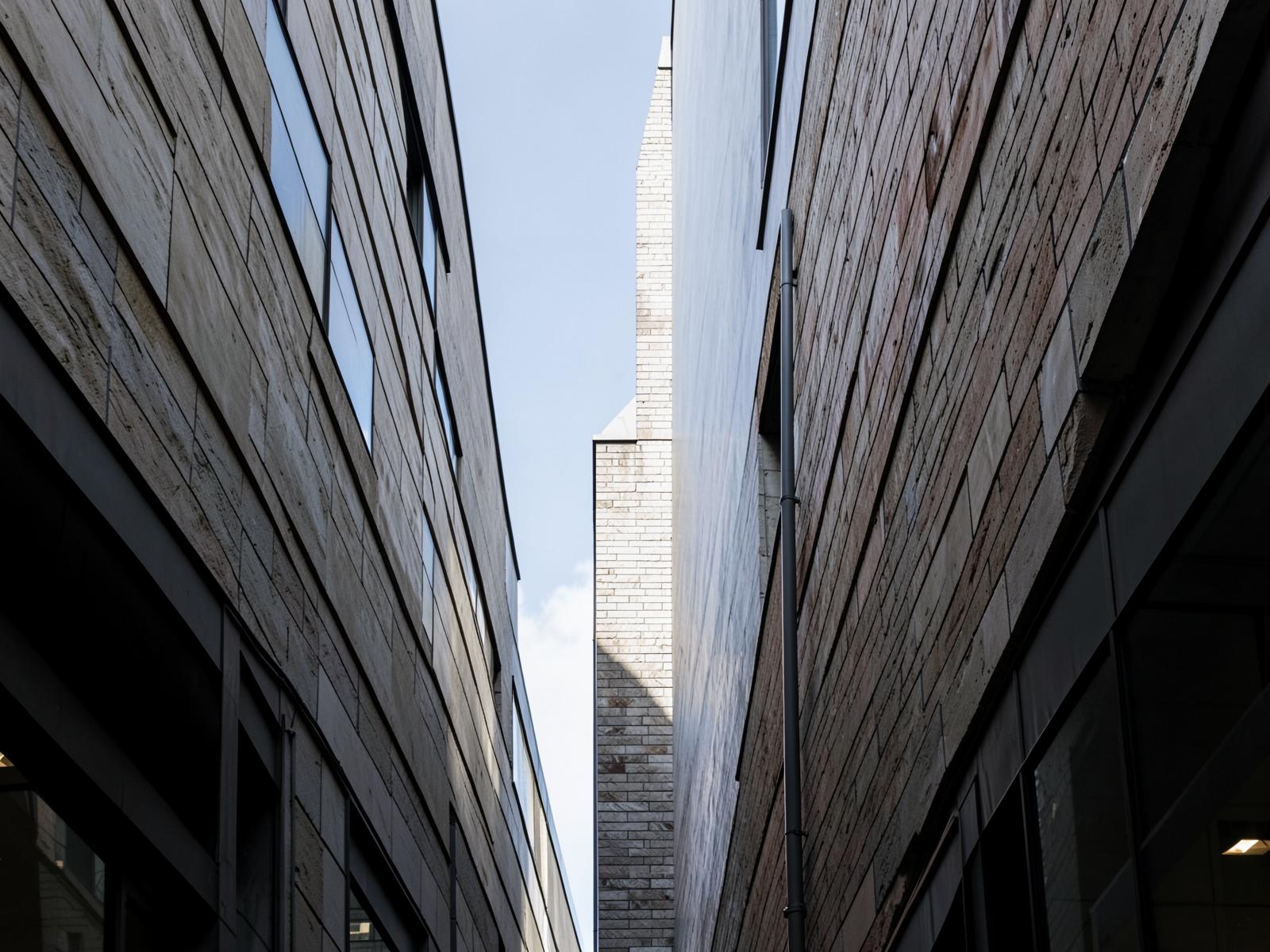 The vertical edge of a masonry commercial building against open sky.