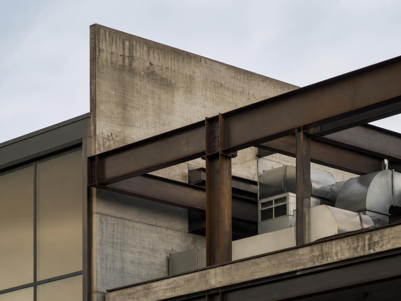 Exposed steel beams, concrete and mechanical services on a commercial building.