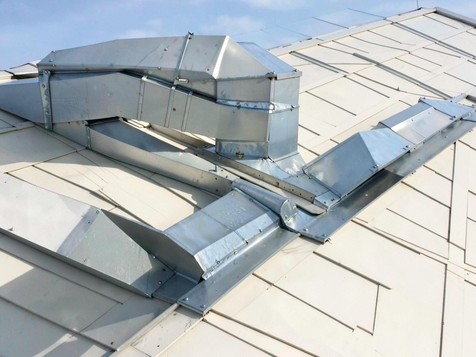 Ductwork and metal flashing detail on a commercial roof.